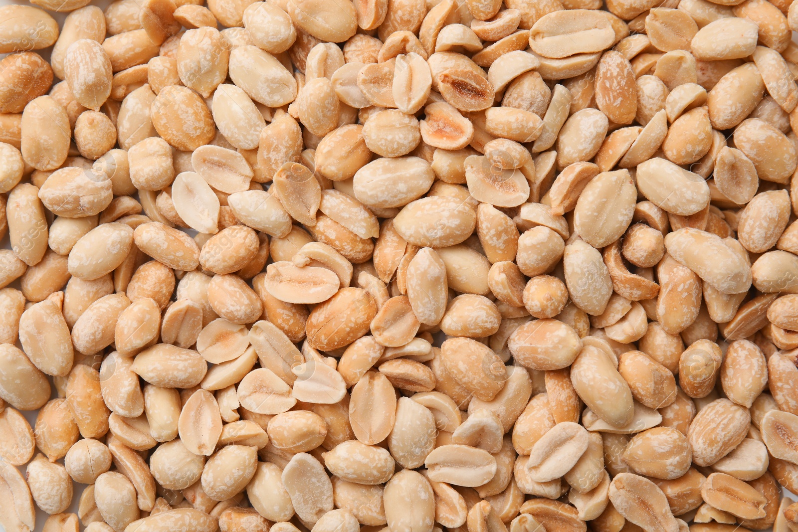 Photo of Many fresh peeled peanuts as background, top view