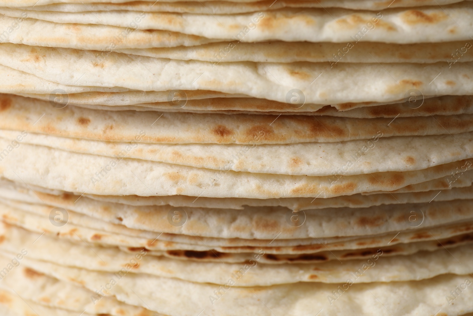 Photo of Stack of tasty tortillas as background, closeup