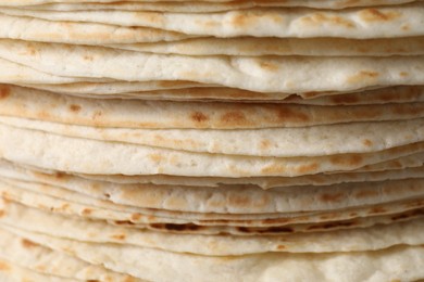 Stack of tasty tortillas as background, closeup