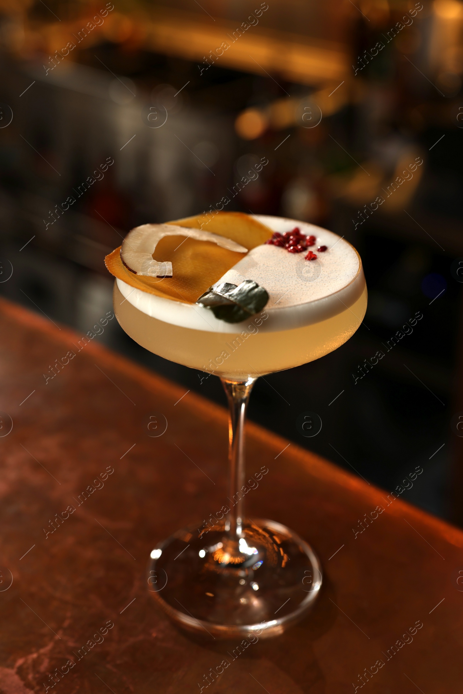 Photo of Fresh alcoholic cocktail on counter in bar, closeup