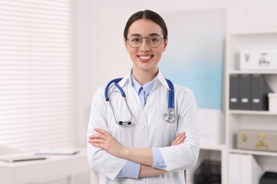 Photo of Medical consultant with glasses and stethoscope in clinic