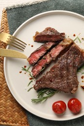 Photo of Delicious grilled beef steak served on table, top view
