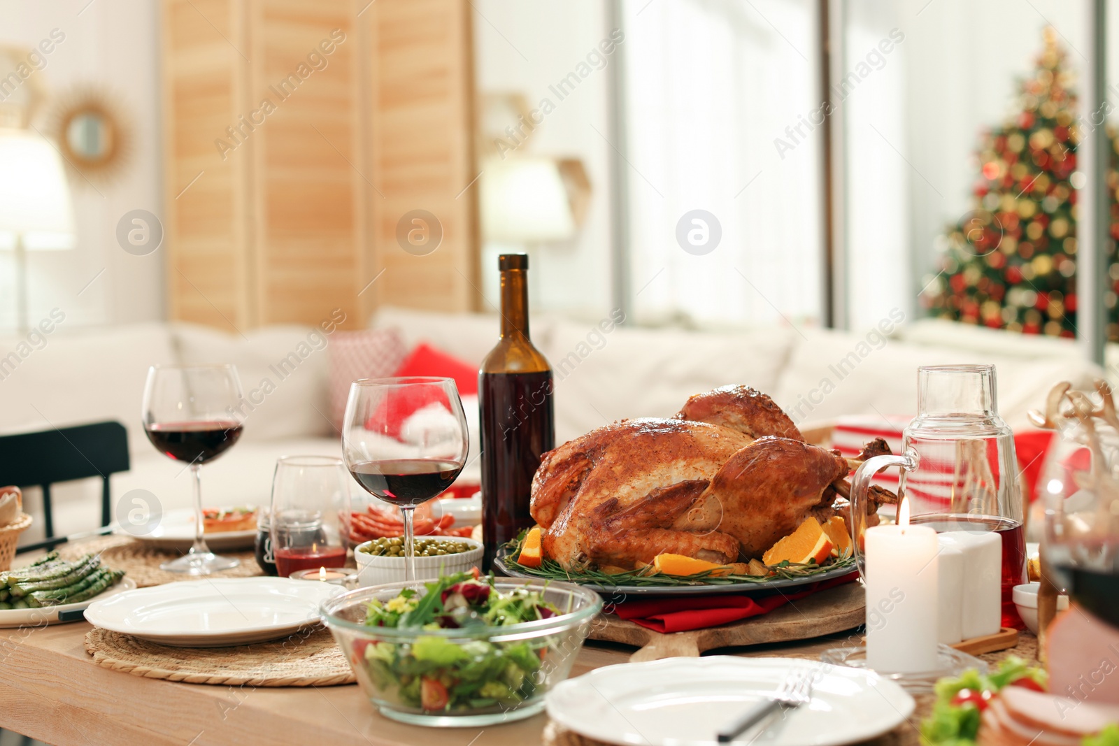 Photo of Festive dinner with delicious food and wine on table indoors. Christmas celebration