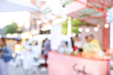 Photo of Blurred view of modern open air cafe on sunny day. Bokeh effect