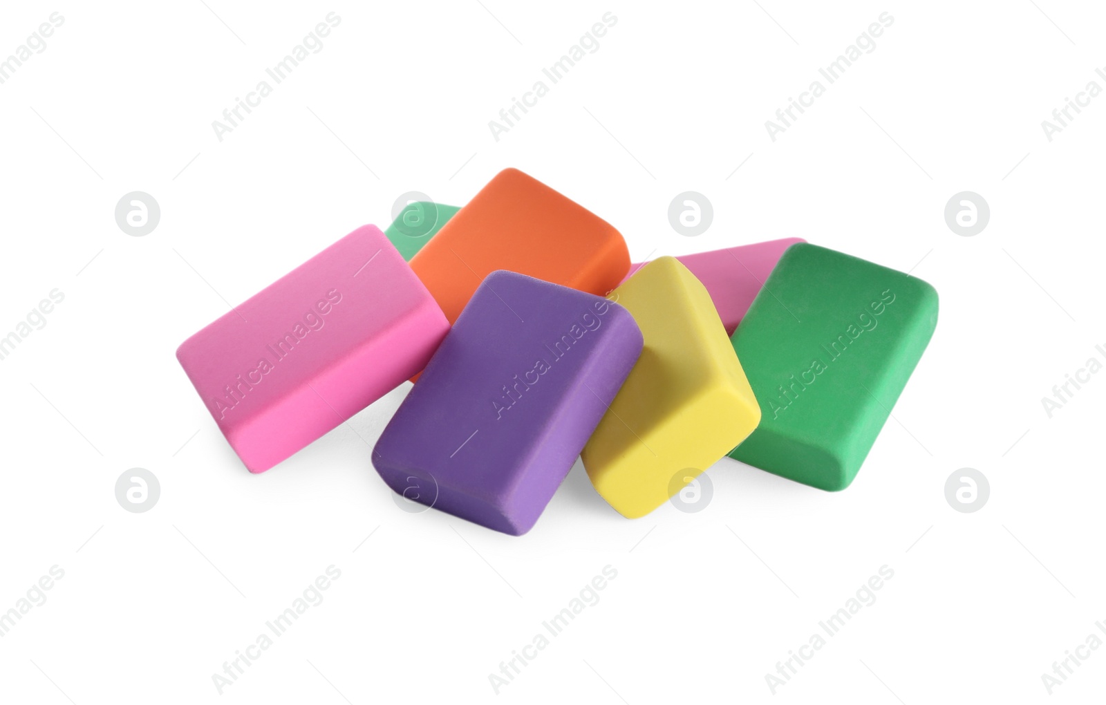 Photo of Pile of bright erasers on white background