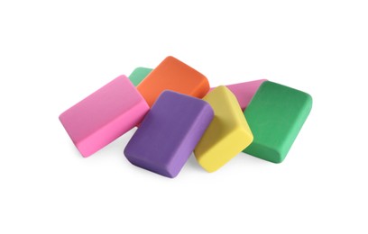 Photo of Pile of bright erasers on white background