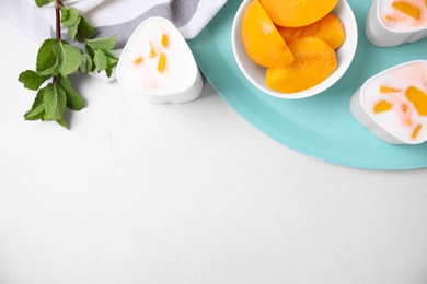 Photo of Flat lay composition with yogurt and ingredients on light background, space for text. Multi cooker recipe