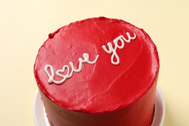 Photo of Bento cake with text Love You on beige table, closeup. St. Valentine's day surprise