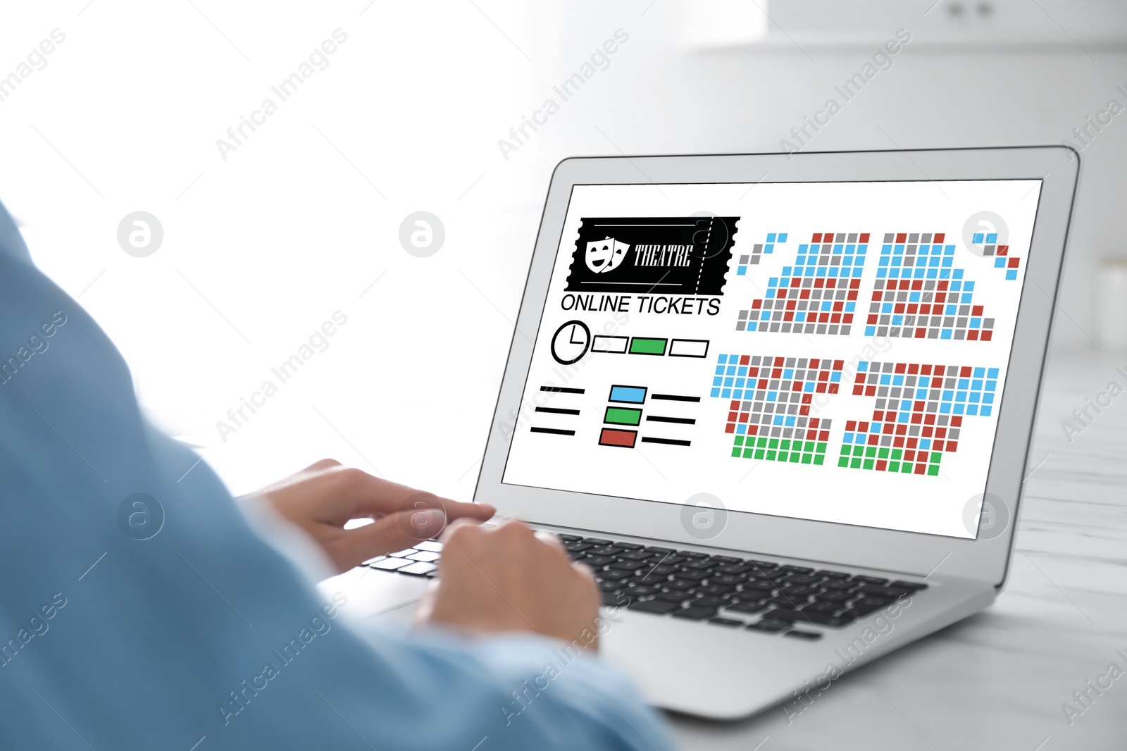 Image of Woman buying theater tickets online via laptop at table, closeup