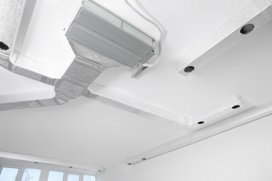 Ceiling with ventilation system indoors, low angle view