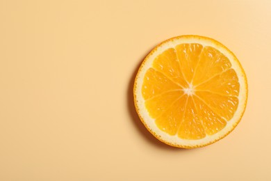Slice of juicy orange on beige background, top view. Space for text