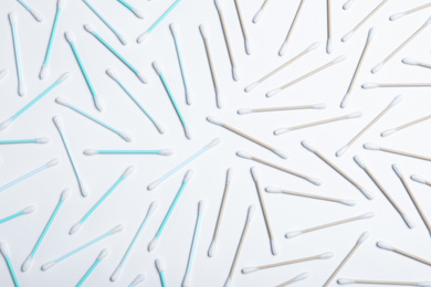 Photo of Plastic and wooden cotton swabs on white background, top view. Recycling concept
