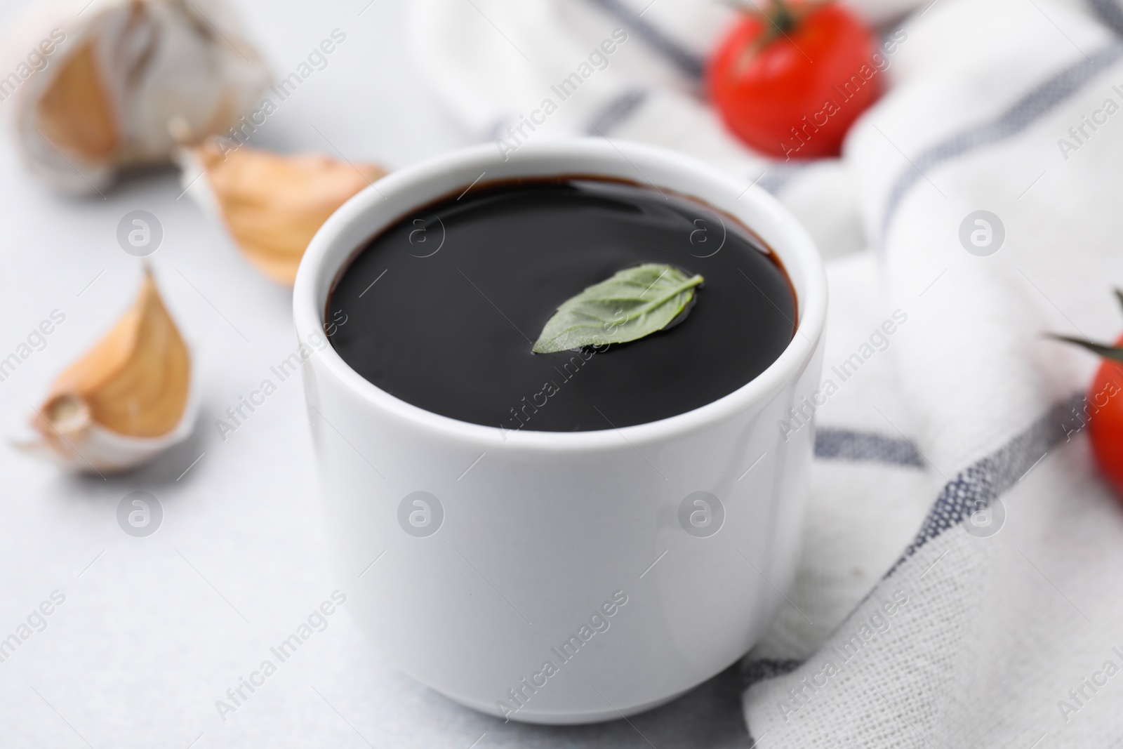 Photo of Organic balsamic vinegar and cooking ingredients on white table