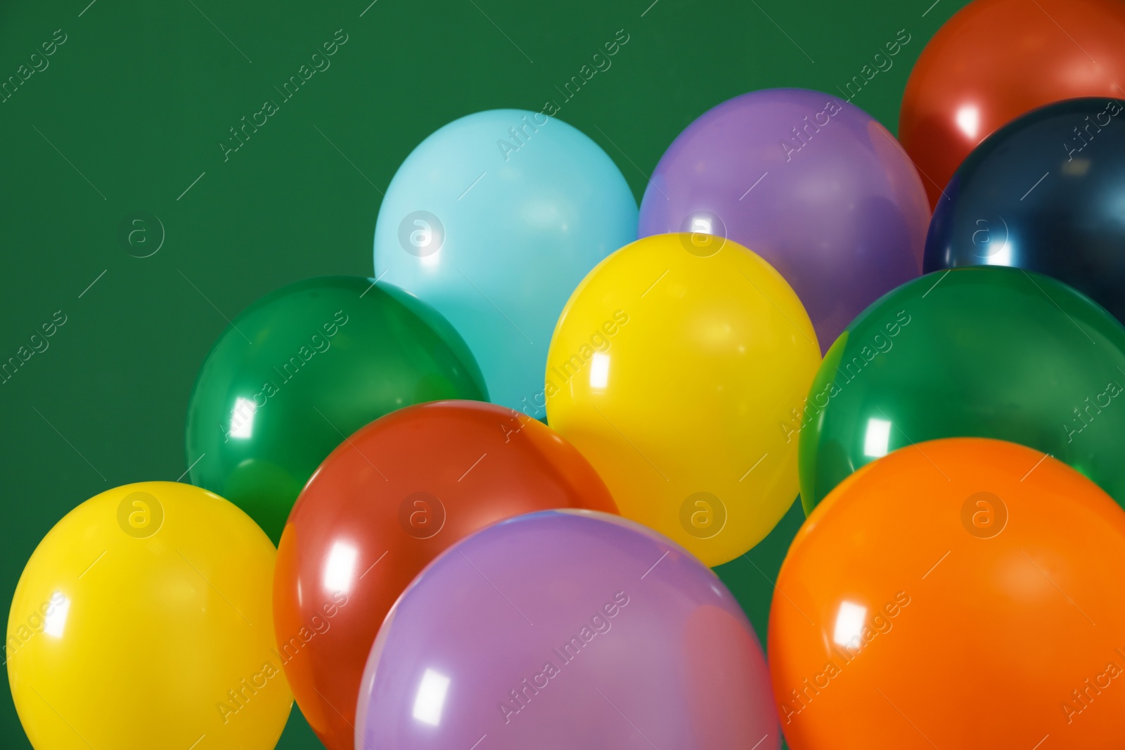 Photo of Bright balloons on color background. Celebration time