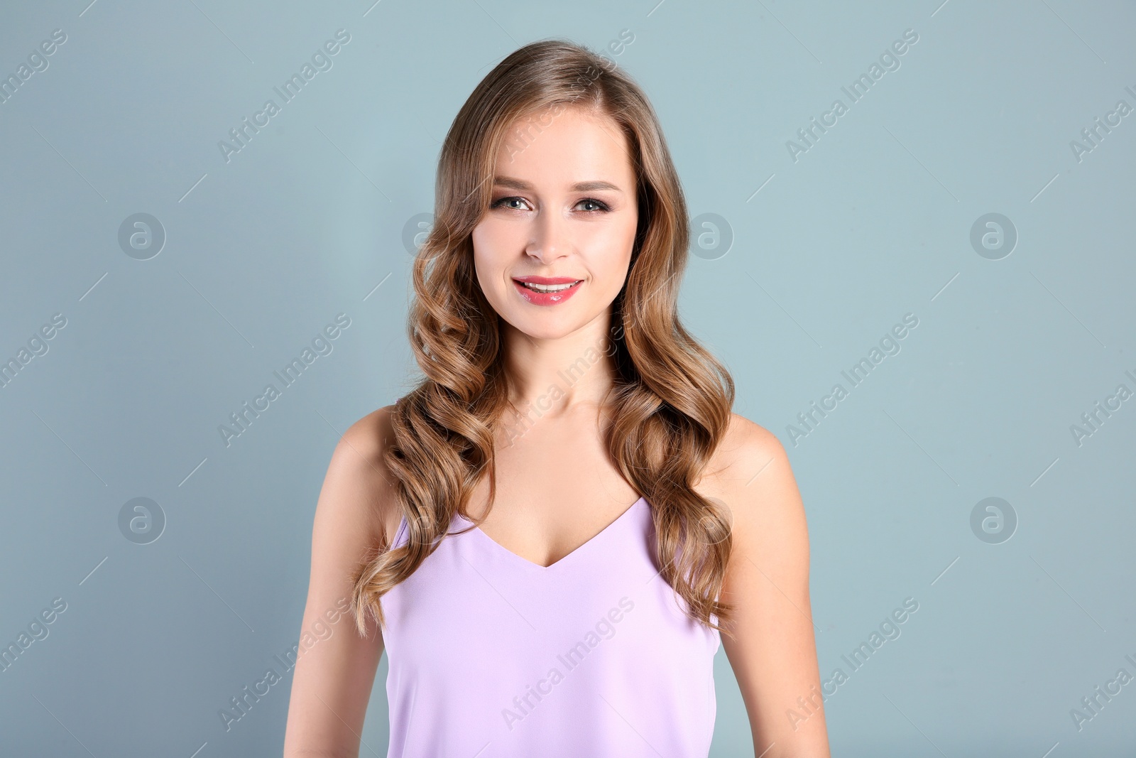 Photo of Portrait of young woman with long beautiful hair on light background