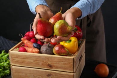 Photo of Farmer holding fresh ripe pears, closeup view. Harvesting time