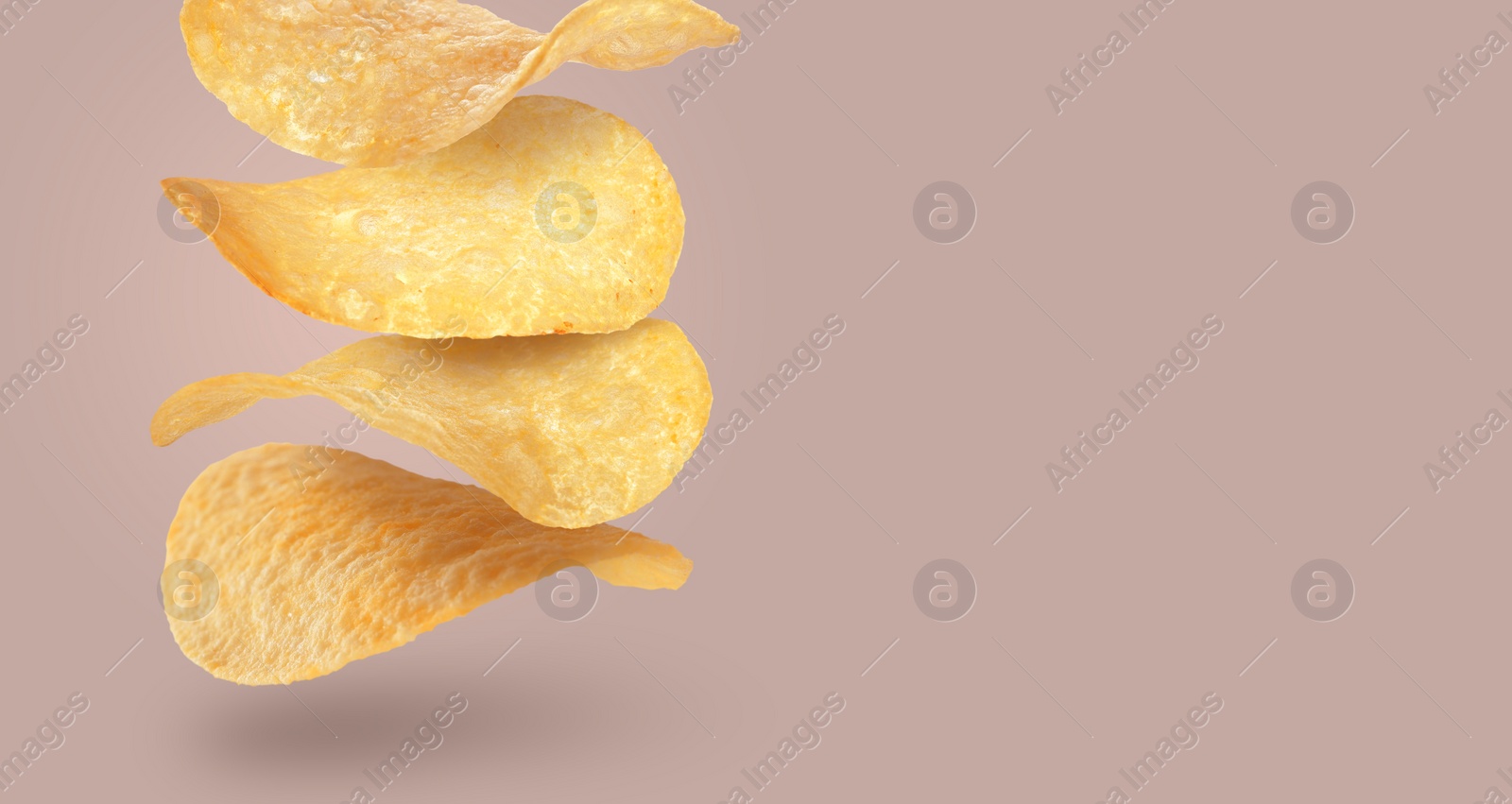 Image of Stack of tasty potato chips falling on color background, space for text