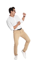 Handsome young man with glasses dancing on white background