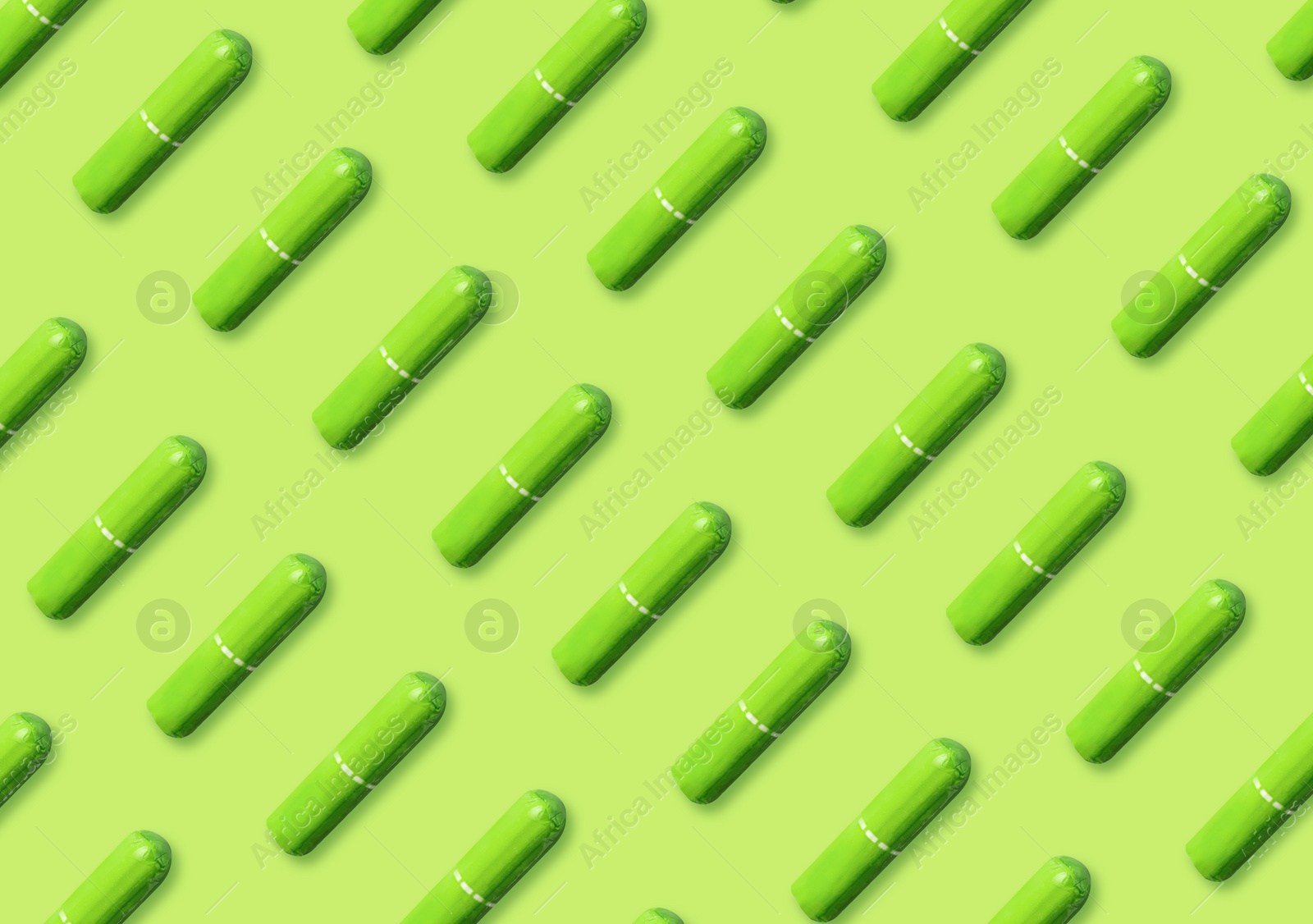 Image of Many tampons on light green background, flat lay 