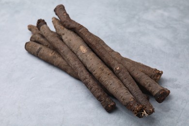 Photo of Fresh raw salsify roots on grey table