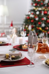 Christmas table setting with beautiful napkin, cutlery and dishware indoors. Space for text