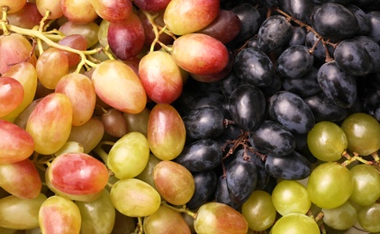 Photo of Fresh ripe juicy grapes as background, top view