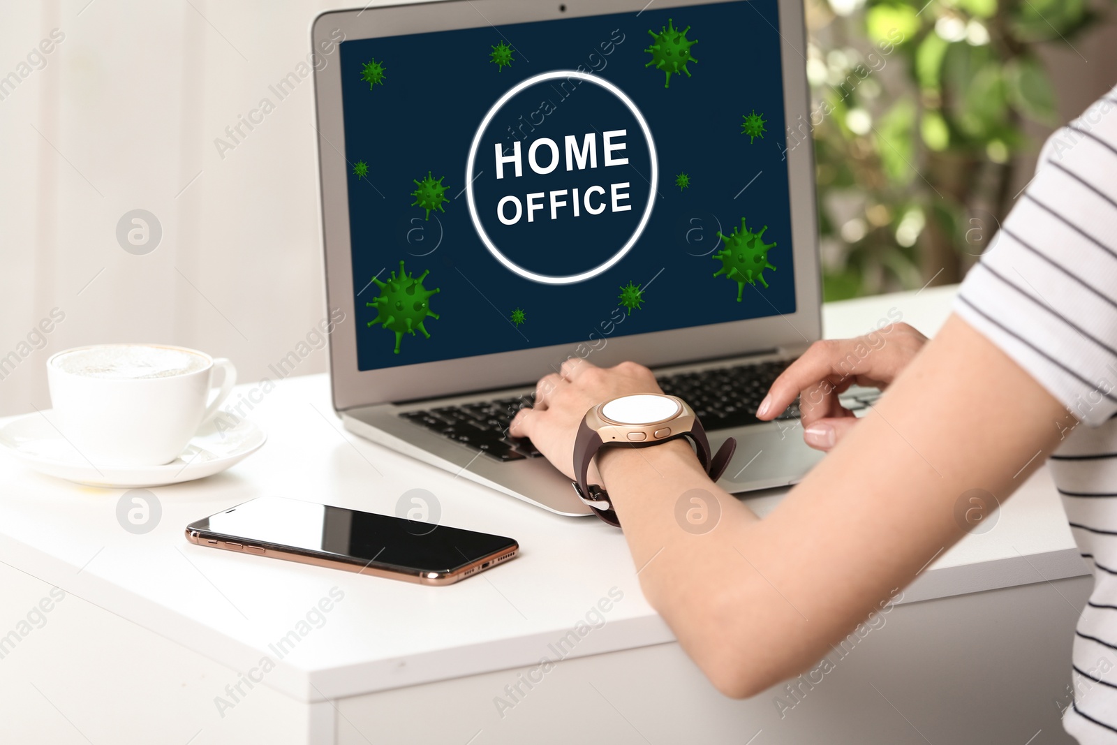 Image of Young woman working with laptop at white table indoors. Home office