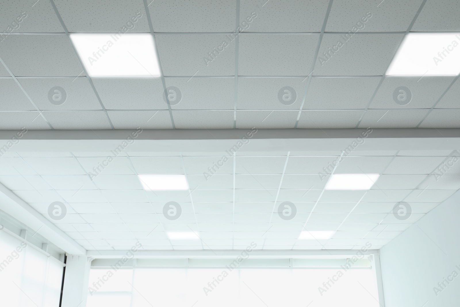 Photo of White ceiling in office room. Interior design