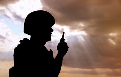 Photo of Soldier with portable radio transmitter outdoors. Military service