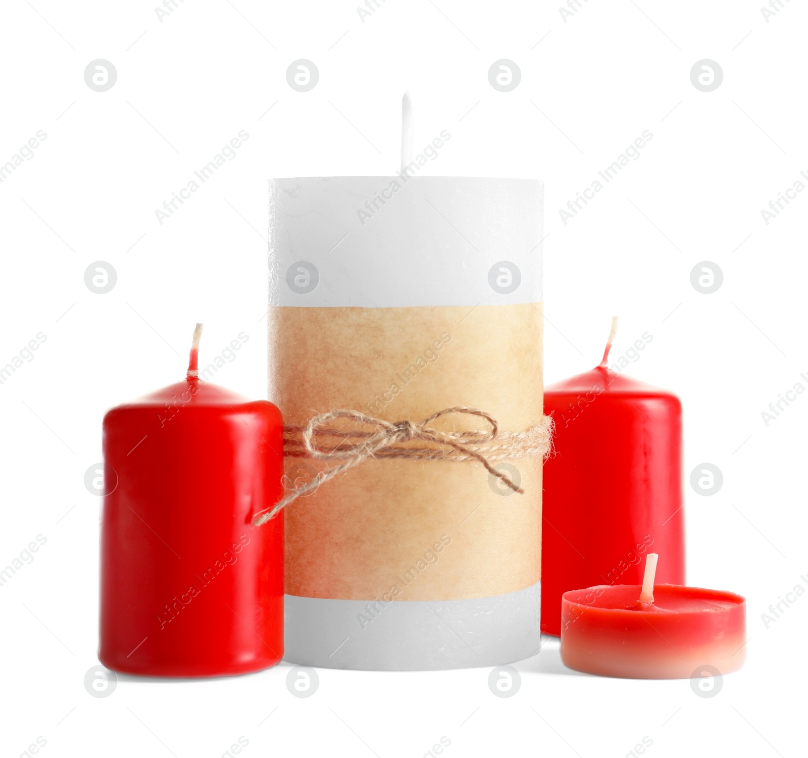 Photo of New wax candles of different shapes on white background