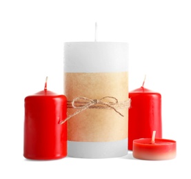 New wax candles of different shapes on white background