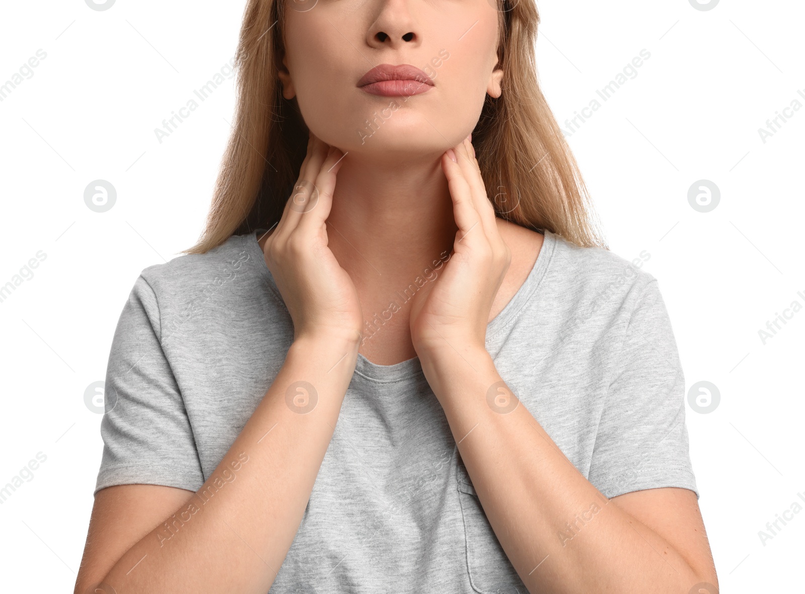 Photo of Young woman doing thyroid self examination on white background, closeup