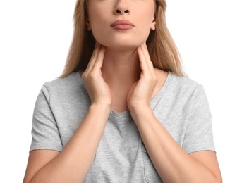 Photo of Young woman doing thyroid self examination on white background, closeup
