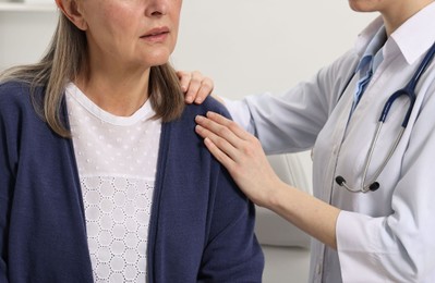 Arthritis symptoms. Doctor examining patient with shoulder pain in hospital