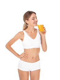 Photo of Happy slim woman in underwear holding glass of juice on white background. Weight loss diet