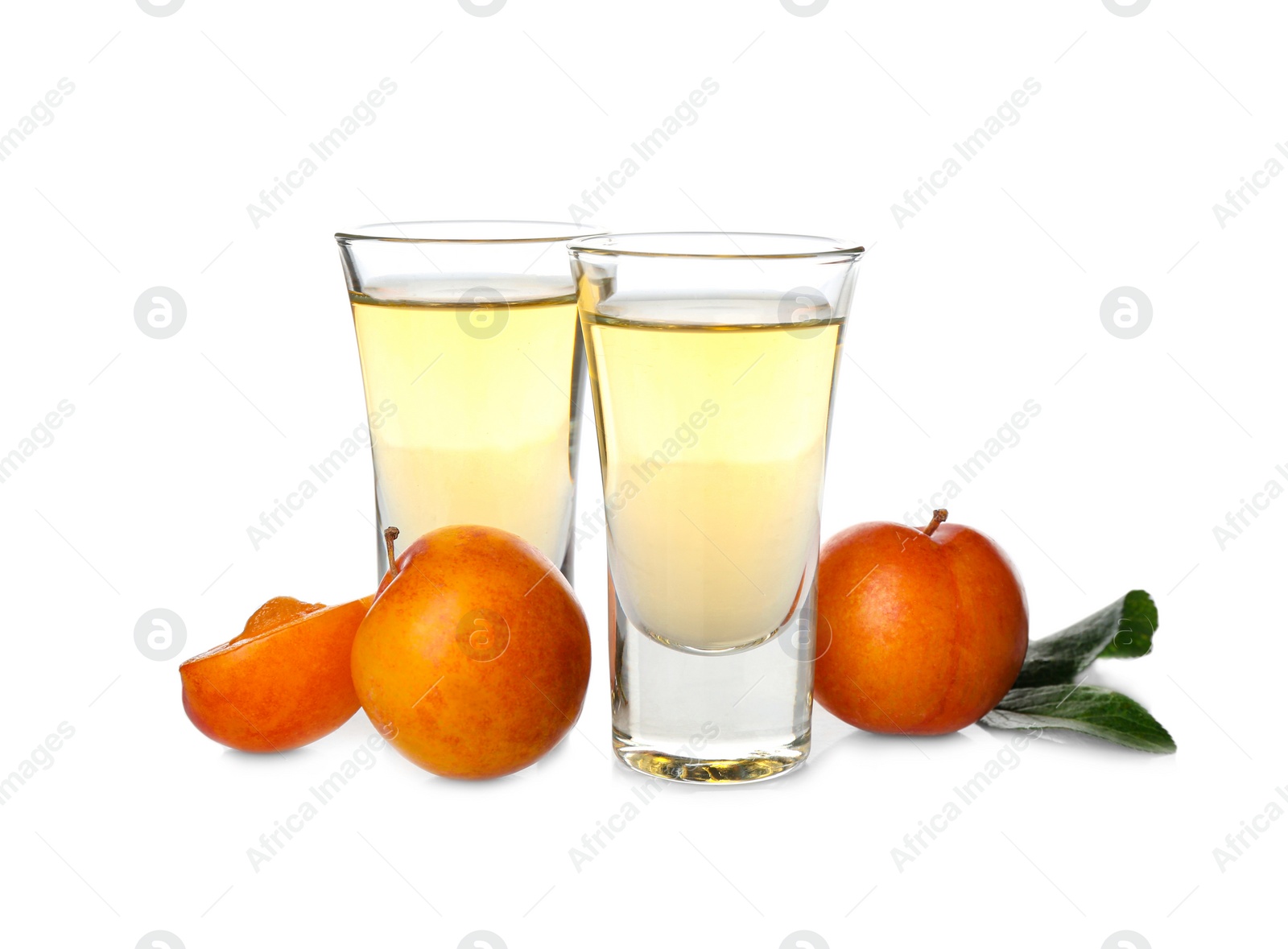 Photo of Delicious plum liquor and ripe fruits on white background. Homemade strong alcoholic beverage