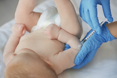 Doctor vaccinating baby in clinic