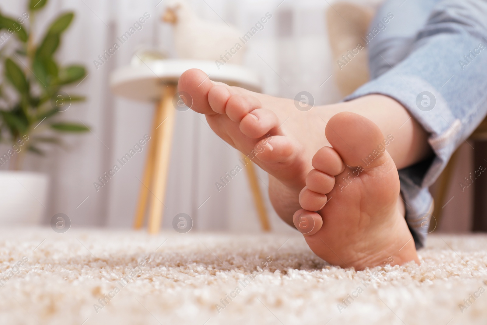 Photo of Woman sitting in armchair at home, closeup. Space for text