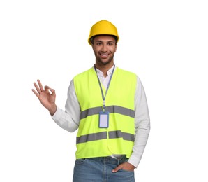 Photo of Engineer with hard hat and badge showing ok gesture on white background