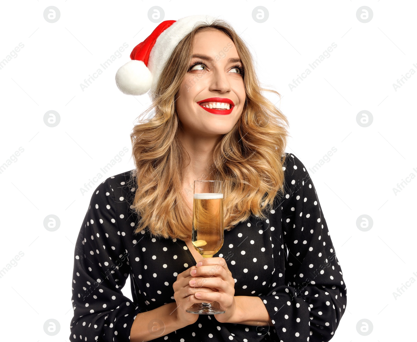 Photo of Happy young woman wearing Santa hat with glass of champagne on white background. Christmas celebration