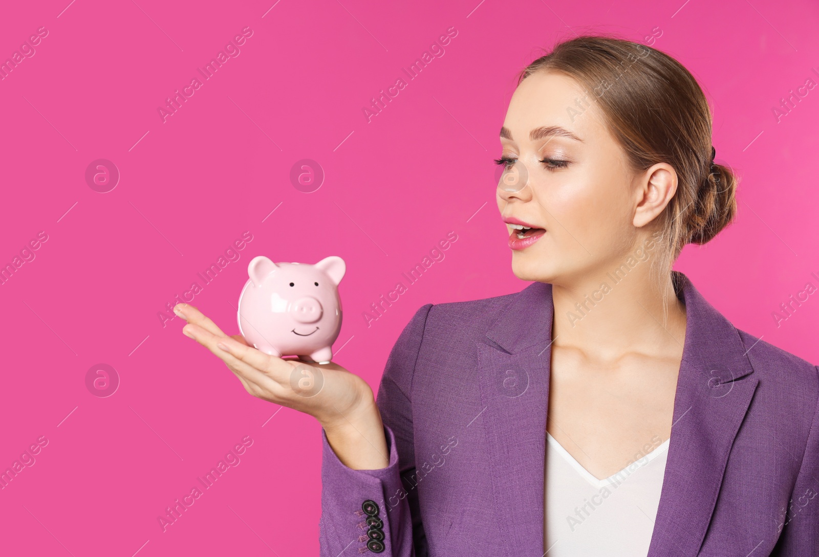 Photo of Happy businesswoman with piggy bank on color background. Money saving