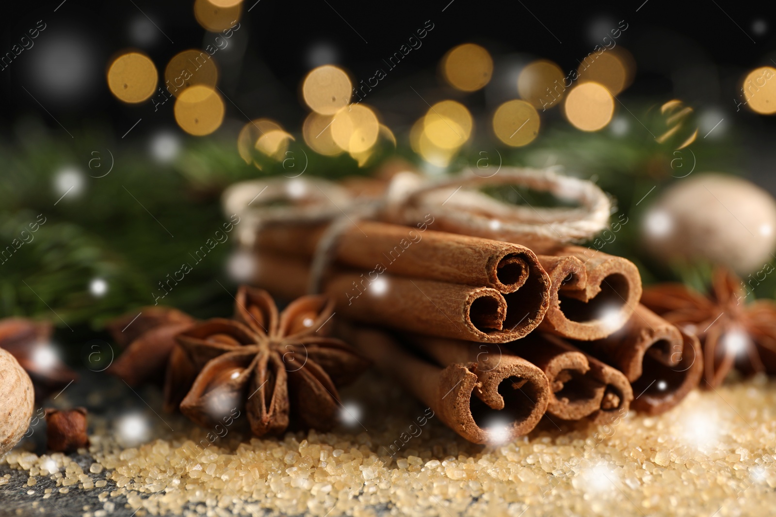 Image of Different spices on table, closeup. Cinnamon, anise, cloves, nutmeg, brown sugar. Bokeh effect