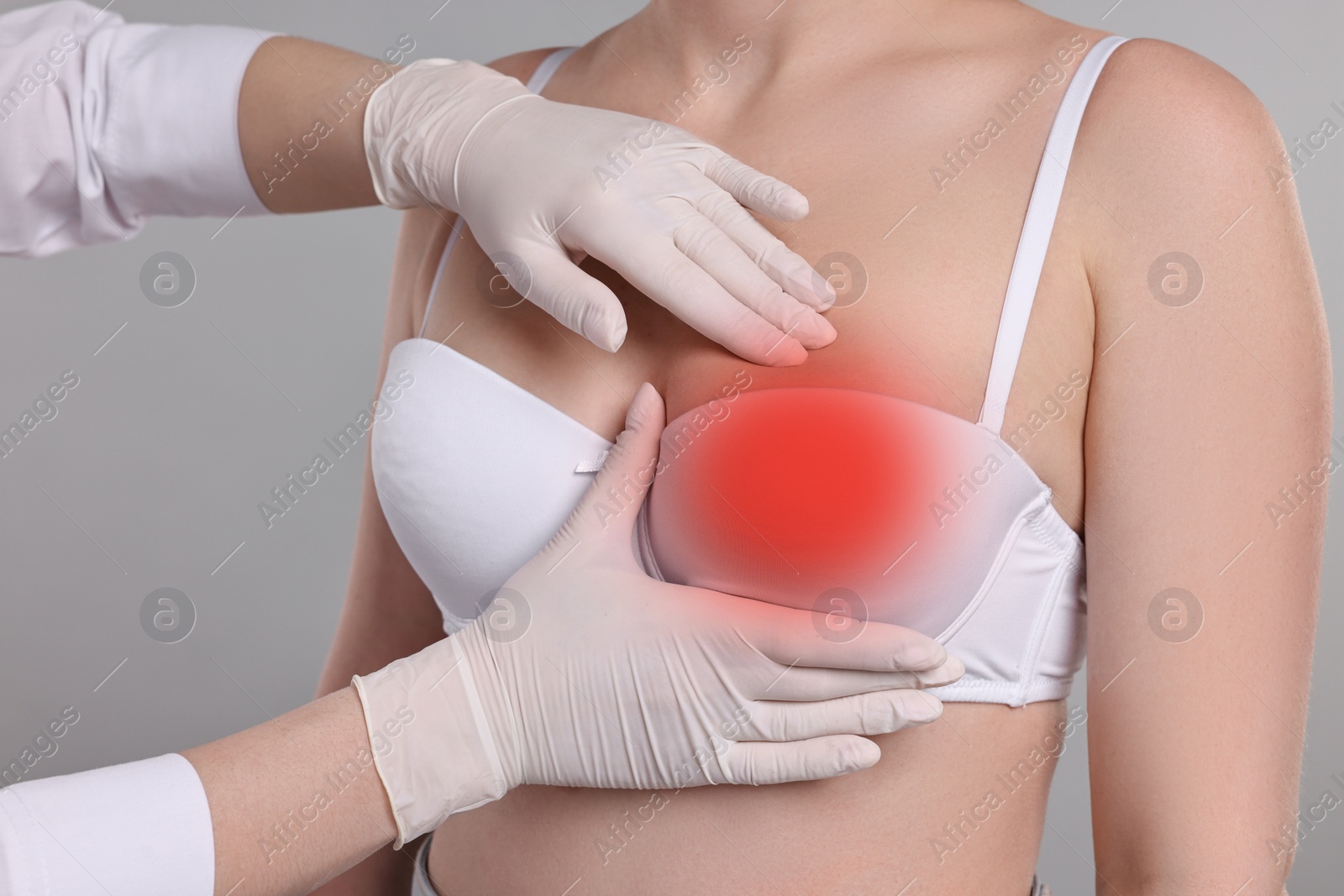 Image of Mammologist checking woman's breast on gray background, closeup