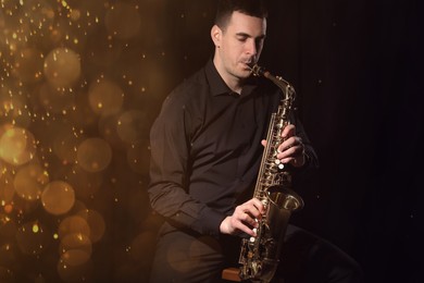 Image of Young man playing saxophone on dark background. Bokeh effect