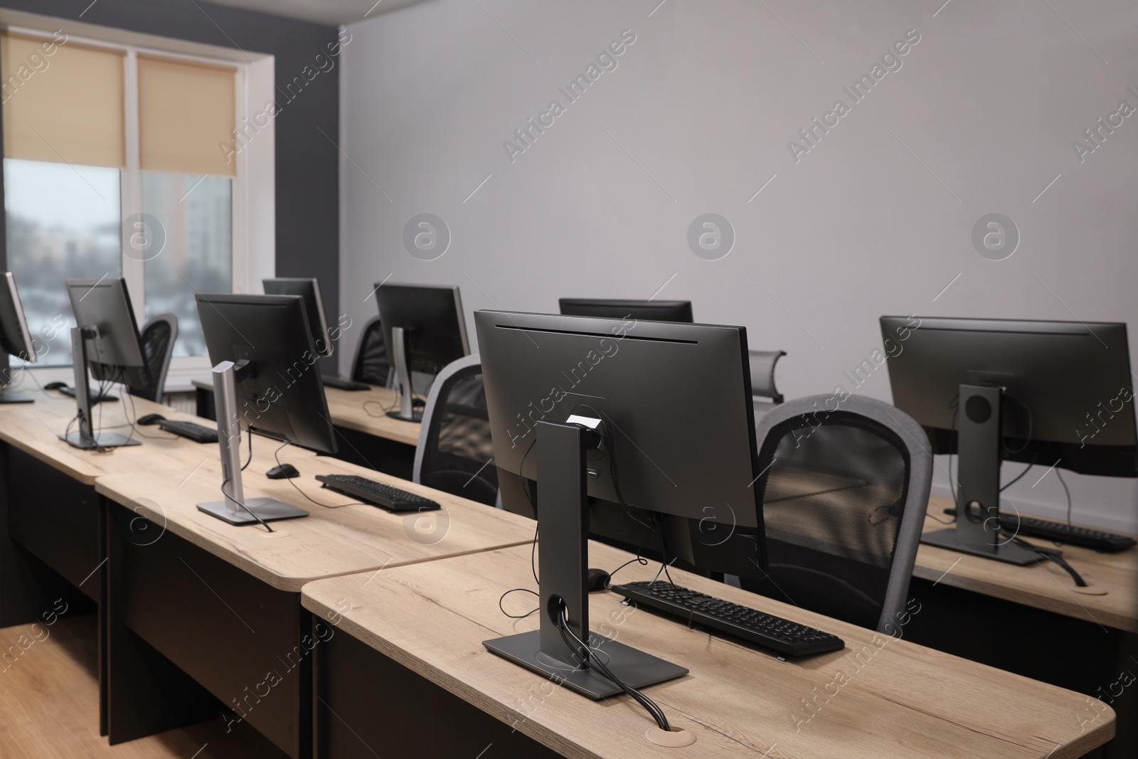 Photo of Many modern computers in open space office