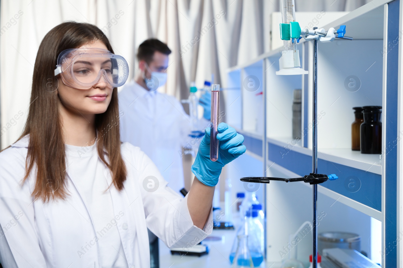 Photo of Scientist holding test tube with liquid indoors. Laboratory analysis