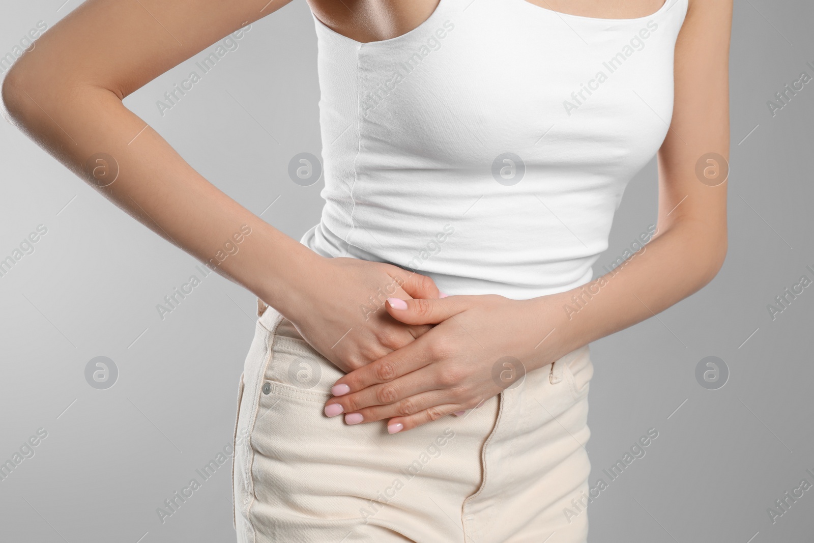 Photo of Woman suffering from appendicitis inflammation on grey background, closeup