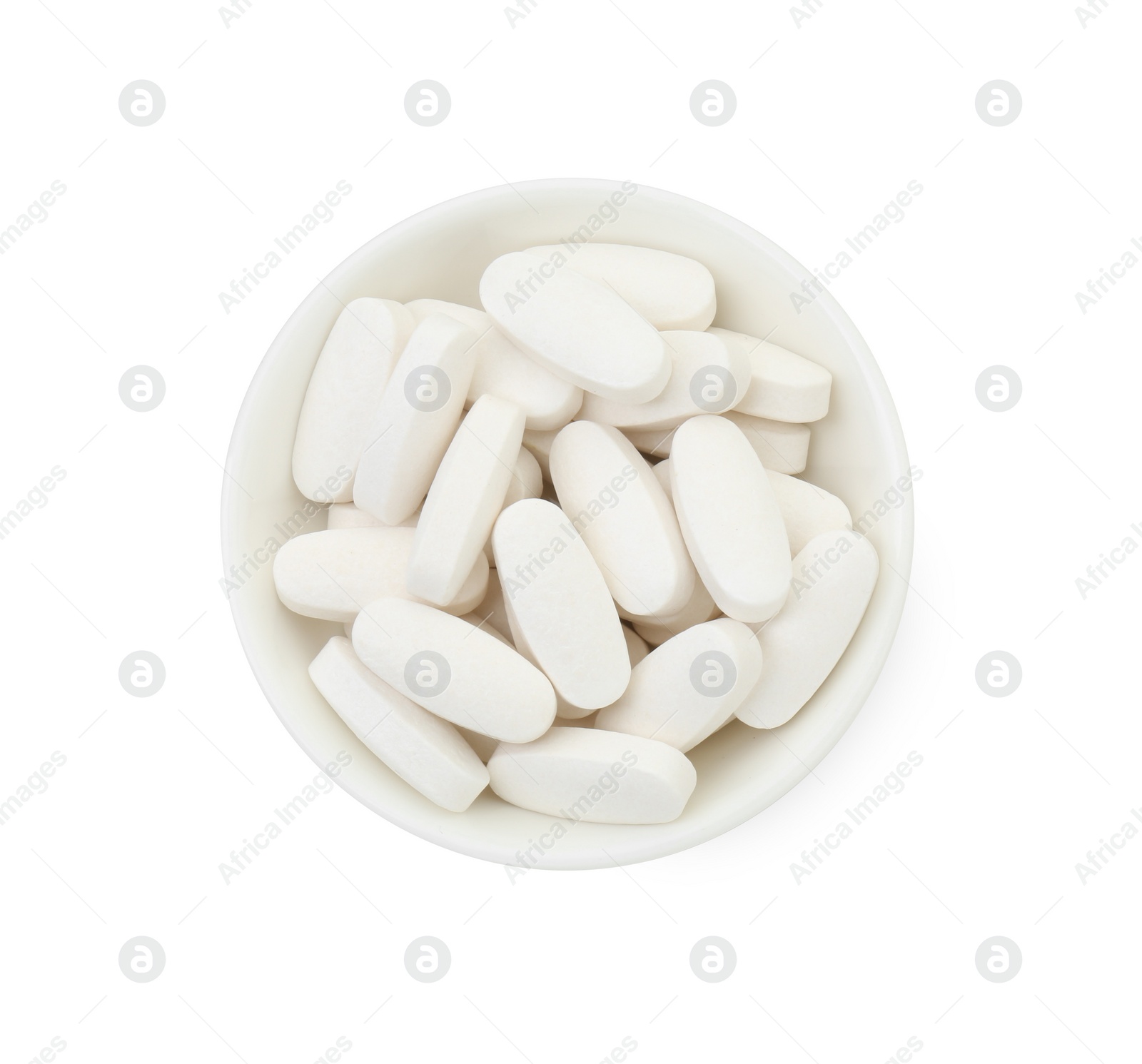 Photo of Vitamin pills in bowl isolated on white, top view. Health supplement