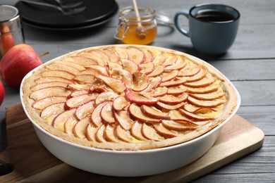 Tasty apple pie on grey wooden table