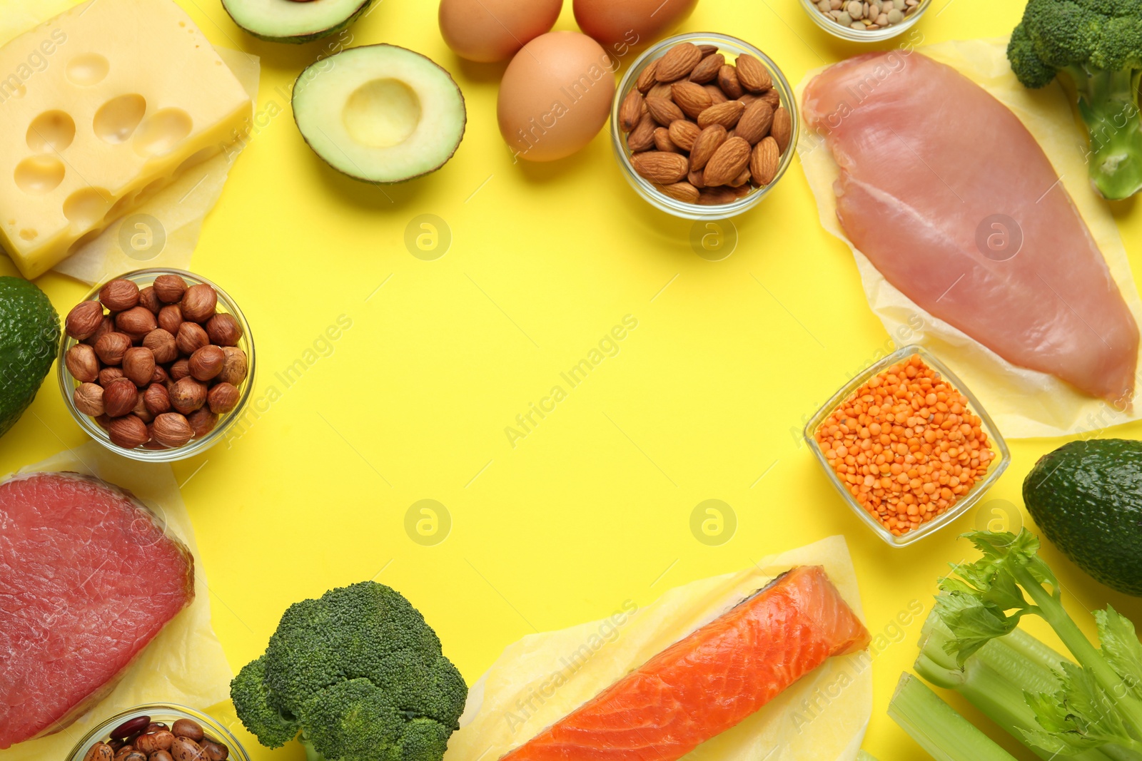 Photo of Frame of products rich in amino acids on yellow background, flat lay. Space for text